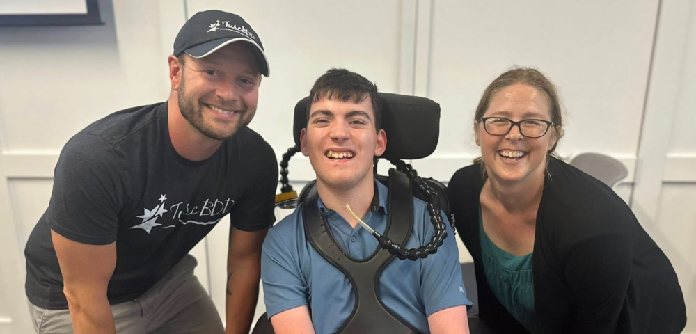 Three people posing and smiling. 